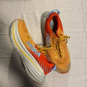 Hoka Bondi X road running shoes in the Fiesta / Amber Yellow colorway
